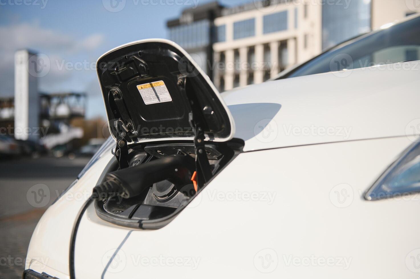 Close Up Of Electric Car Being Charged photo