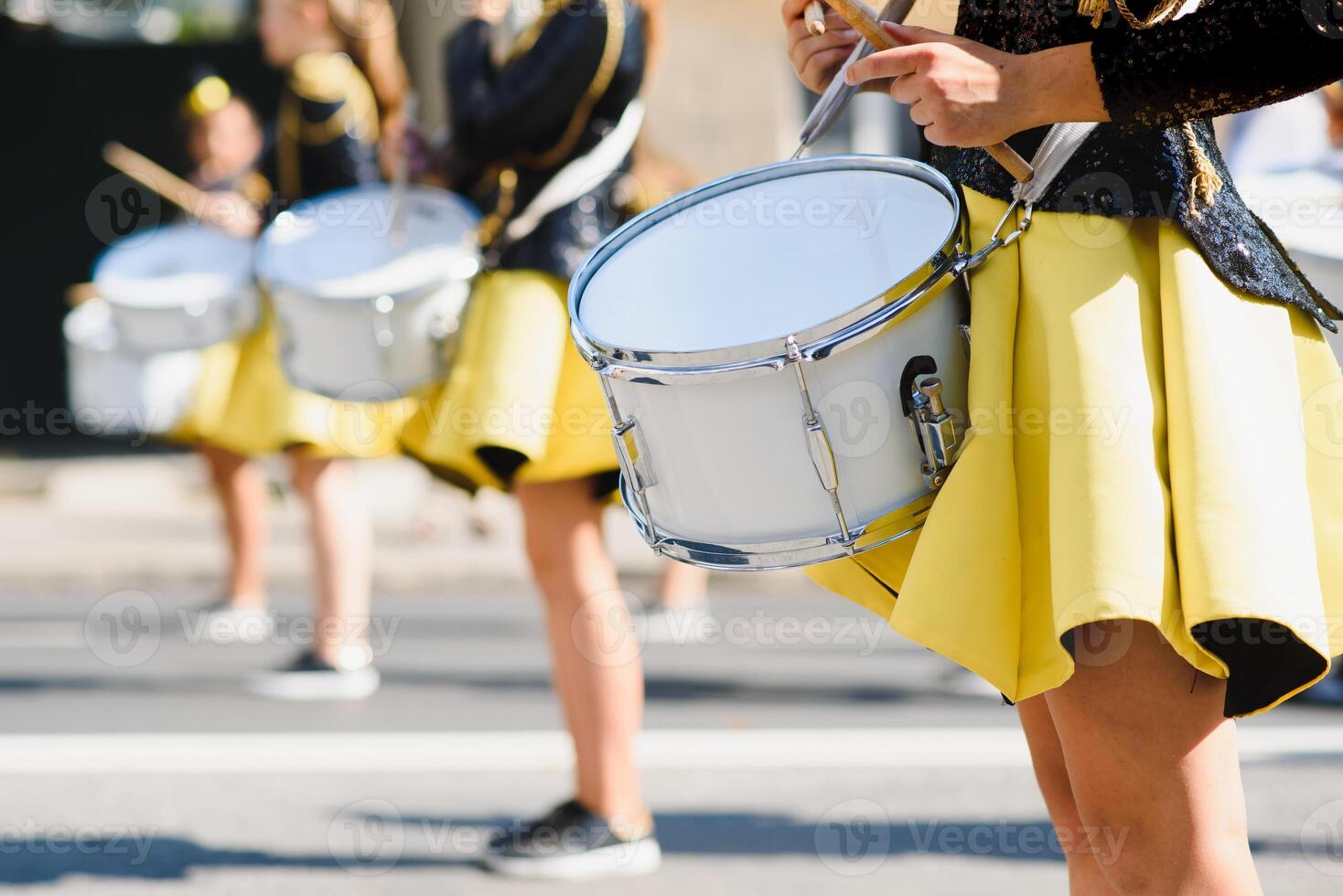 group of majorettes parade through the streets of the city photo