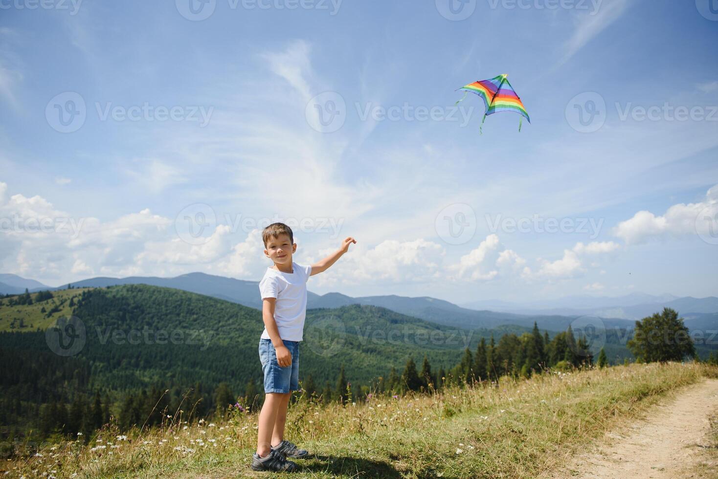 Young boy flies his kite in an open field. a pictorial analogy for aspirations and aiming high photo