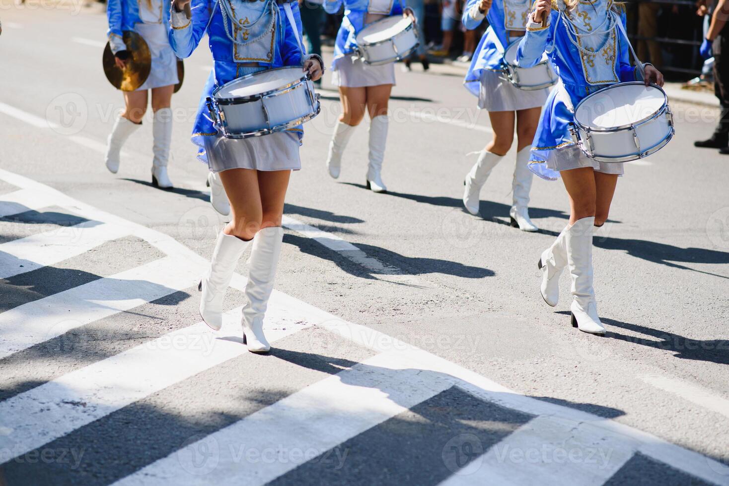 majorettes with white and blue uniforms perform in the streets of the city. photographic series photo