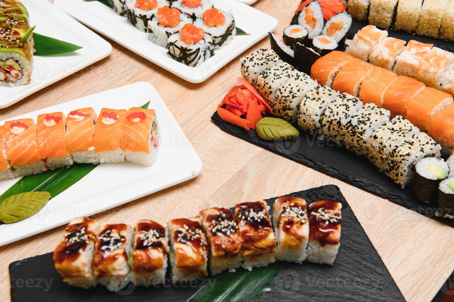 Japanese rolls on black background isolated with reflections photo