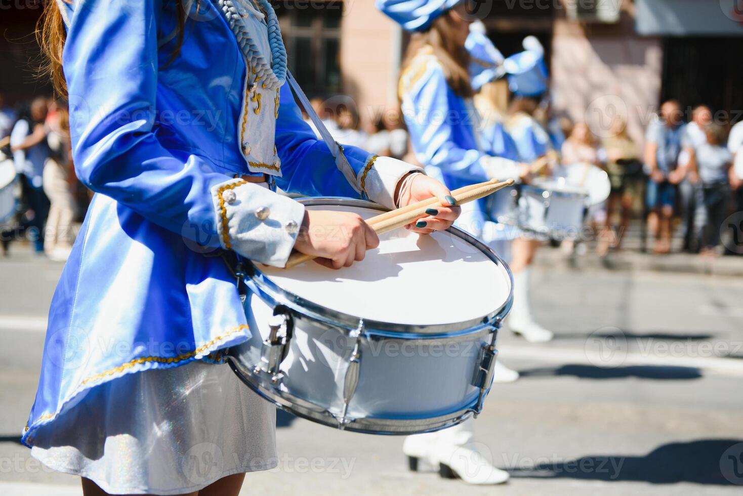 majorettes with white and blue uniforms perform in the streets of the city. photographic series photo