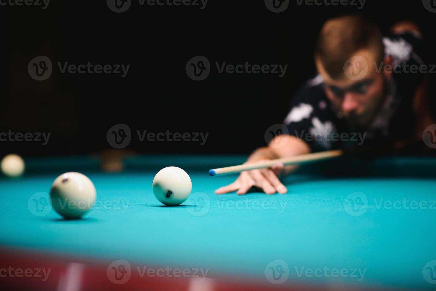 game of billiards the hand of a man with a billiard cue aims at a billiard ball photo