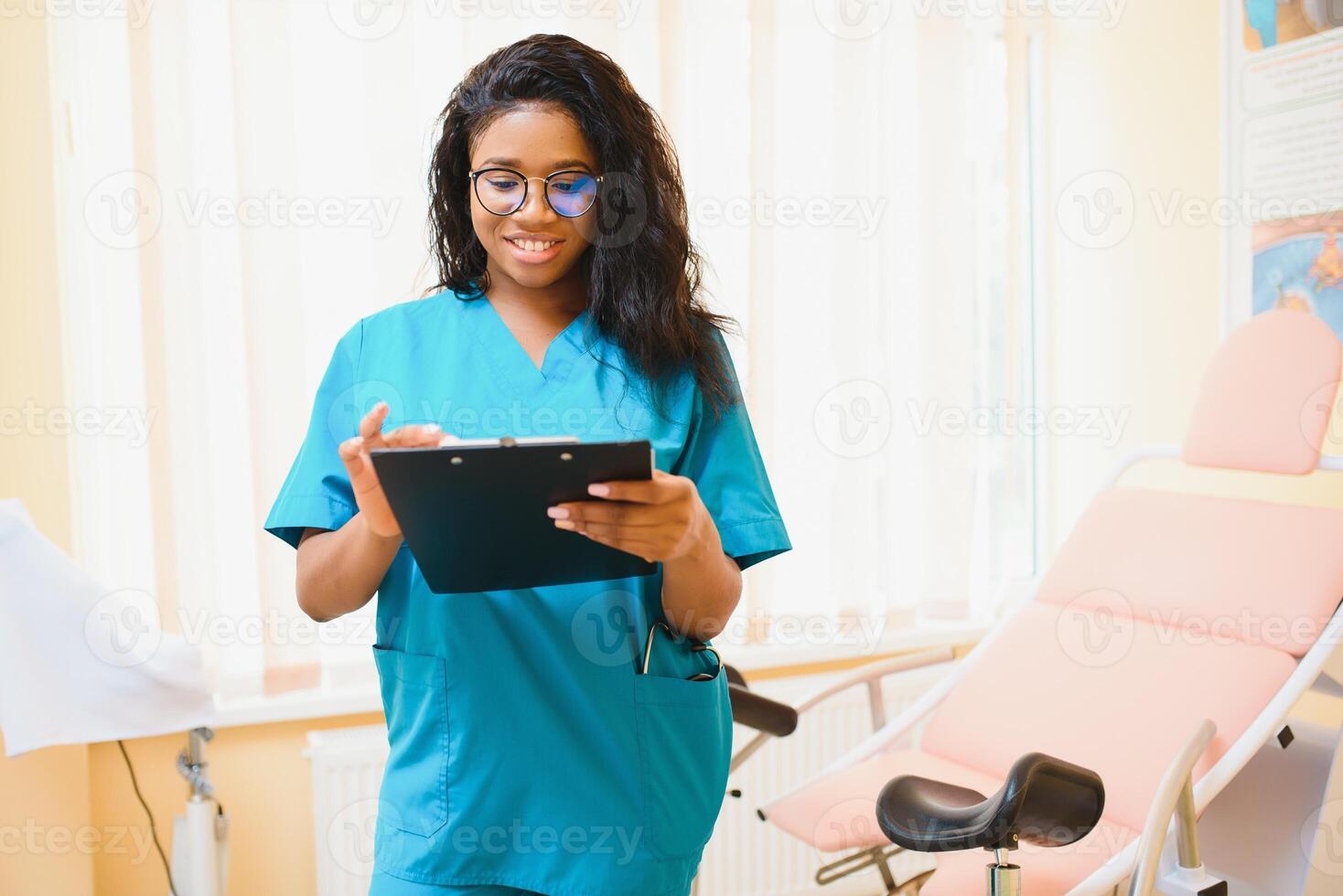 Professional female doctor on blurred consulting room background. African American gynecologist. Gynecology concept. photo