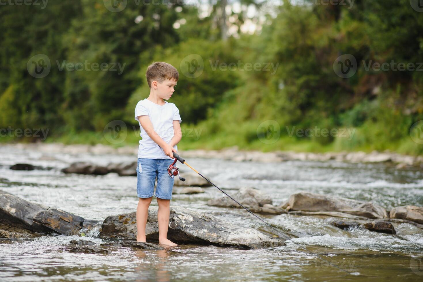 https://static.vecteezy.com/system/resources/previews/040/743/105/non_2x/cute-boy-in-white-t-shirt-fishing-in-the-river-and-has-fun-smiles-vacation-with-kids-holidays-active-weekends-concept-photo.jpg