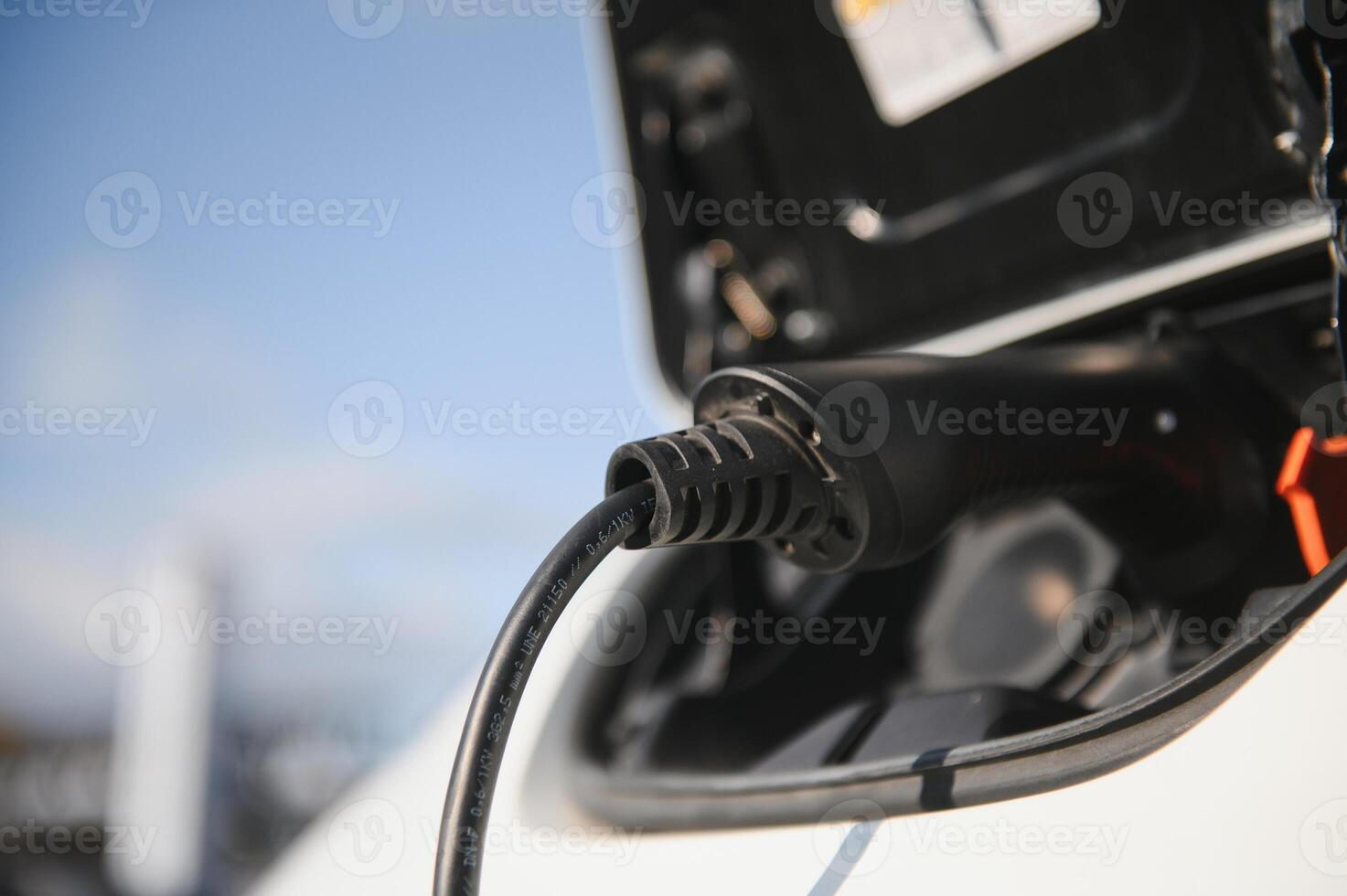 Close Up Of Electric Car Being Charged photo