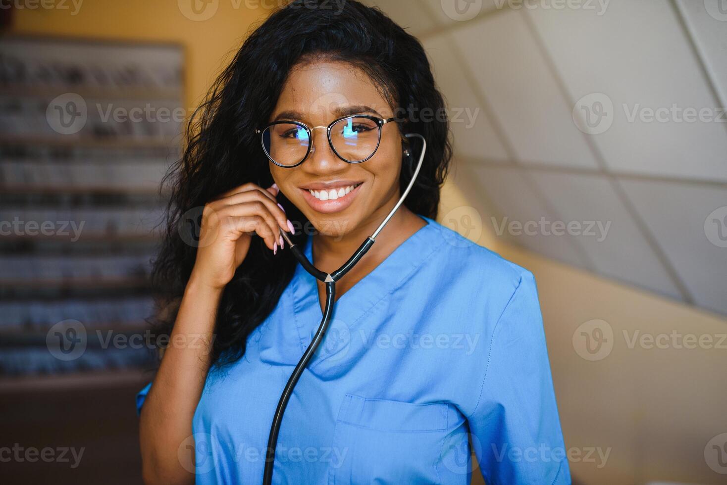 pretty female african doctor with arms crossed at hospital photo