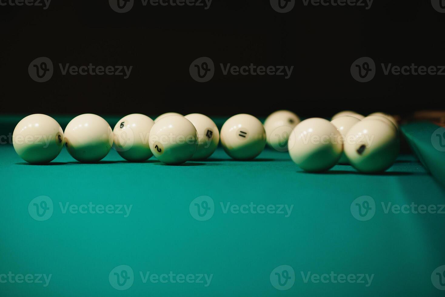 game of billiards the hand of a man with a billiard cue aims at a billiard ball photo