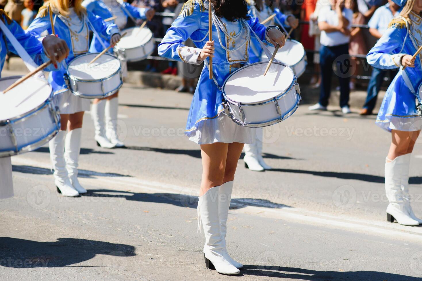 majorettes with white and blue uniforms perform in the streets of the city. photographic series photo