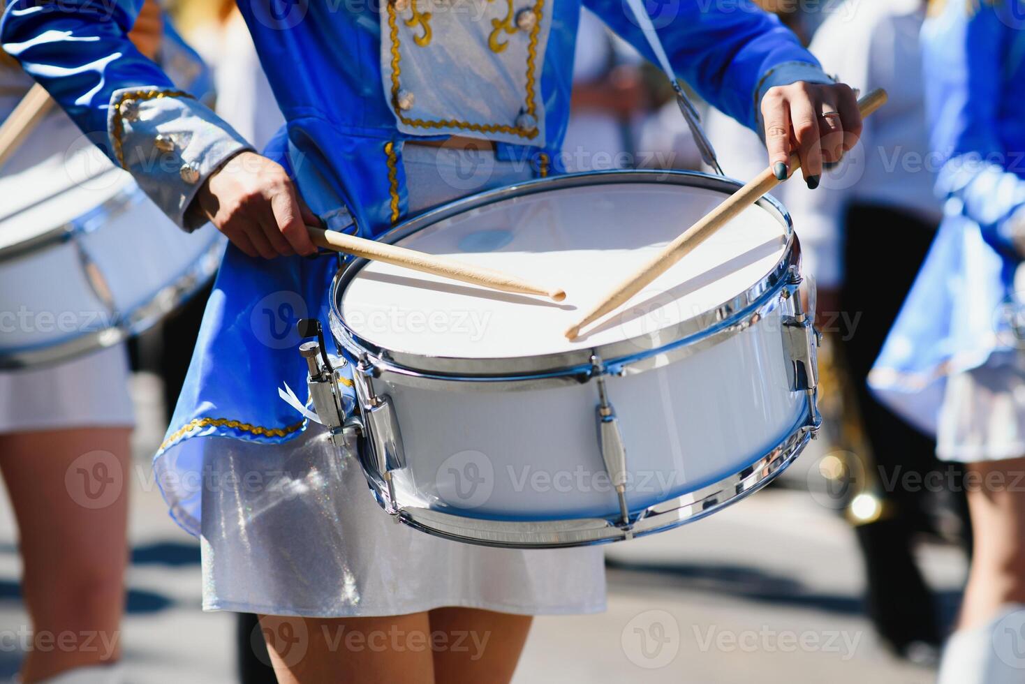 majorettes with white and blue uniforms perform in the streets of the city. photographic series photo