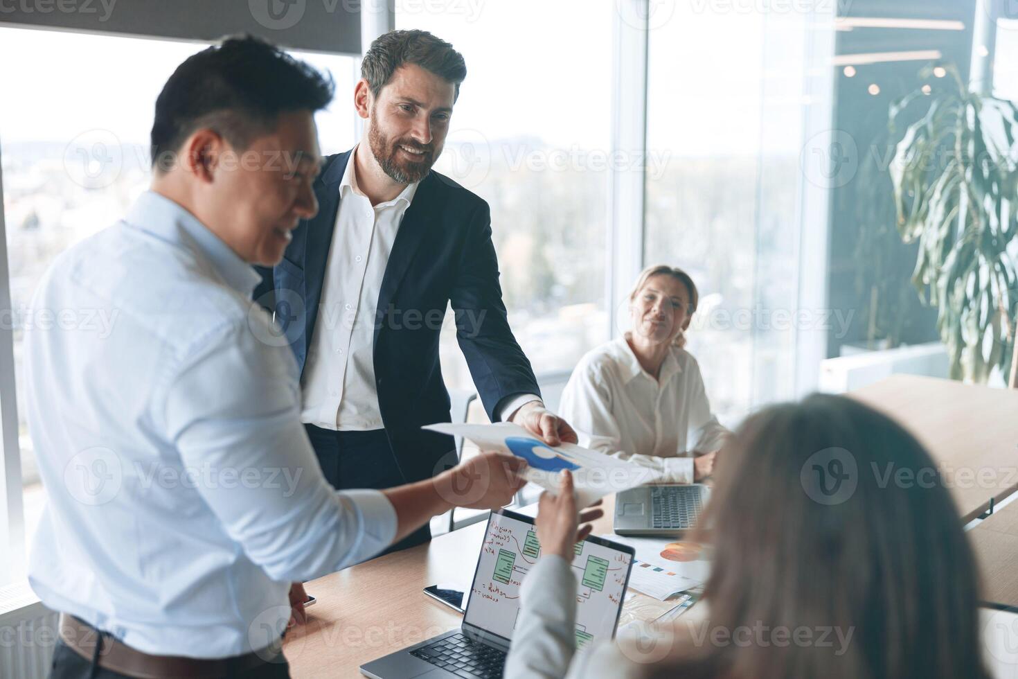 Confident and successful team. Group of modern people are working together in office photo