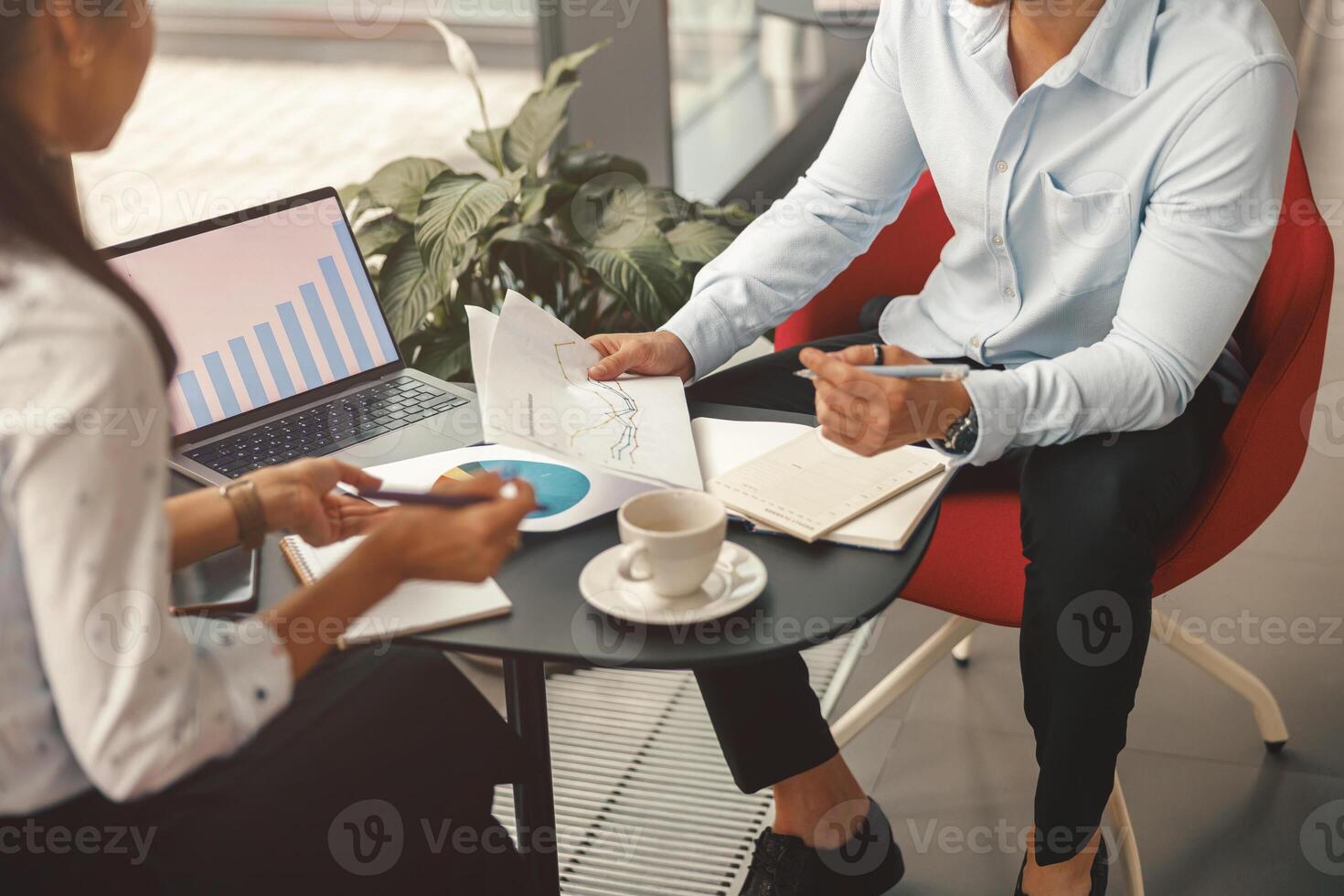 Close up of business colleagues working together with financial statements in stylish meeting room photo