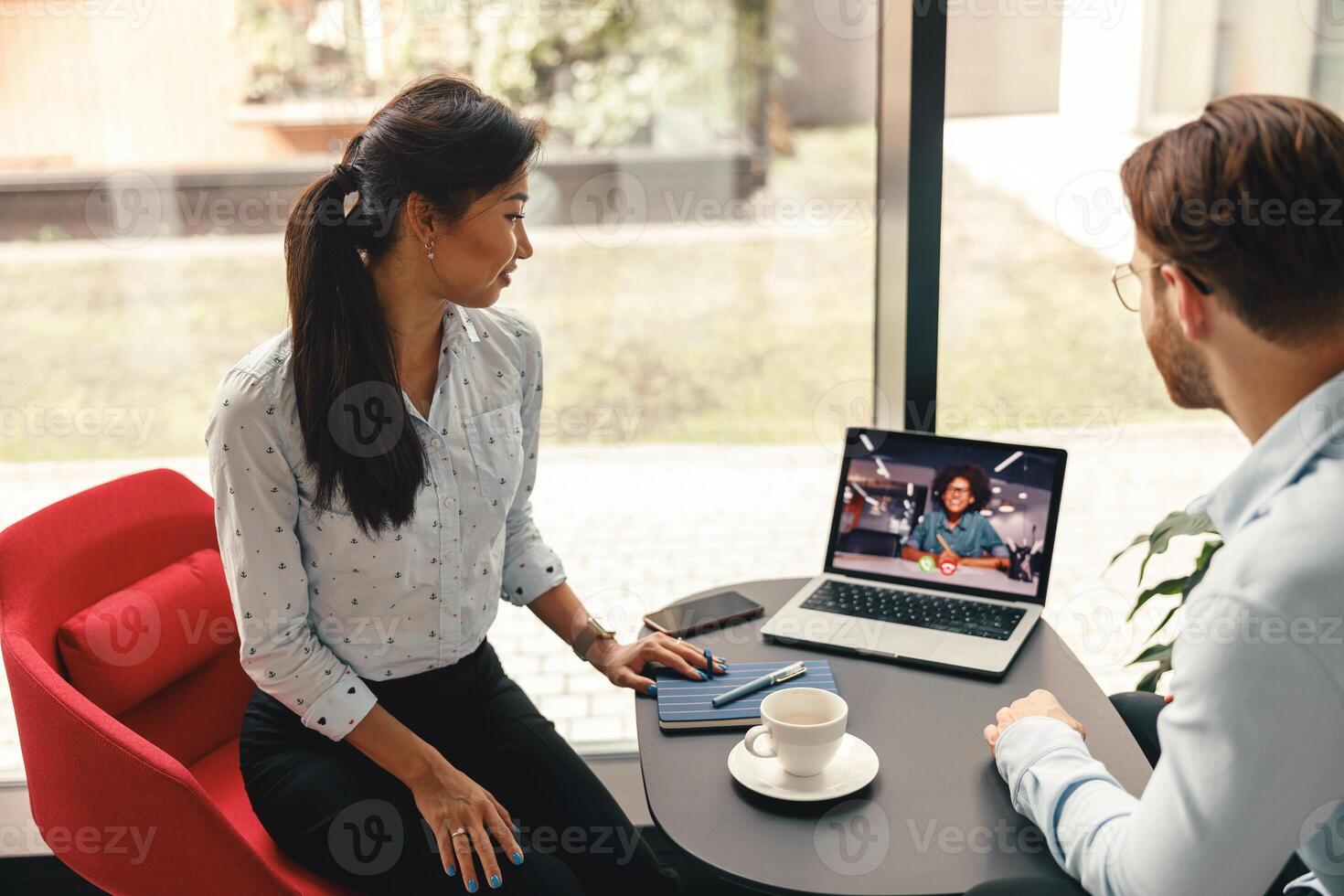 Team of managers working together on project during online video call meeting conference in office photo