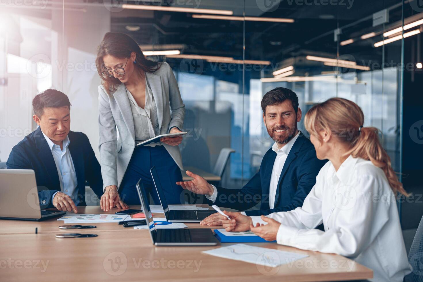 Woman explaining her ideas to colleagues in conference room at modern office photo