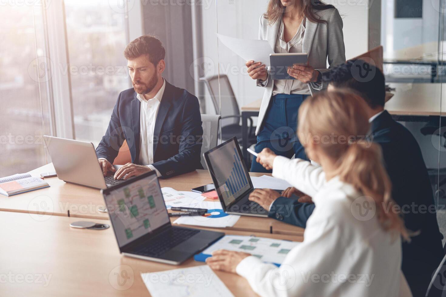 Office colleagues having casual discussion during meeting in conference room photo