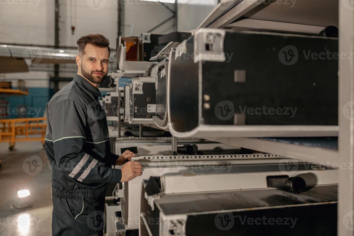Bearded man airplane mechanic working in hangar photo