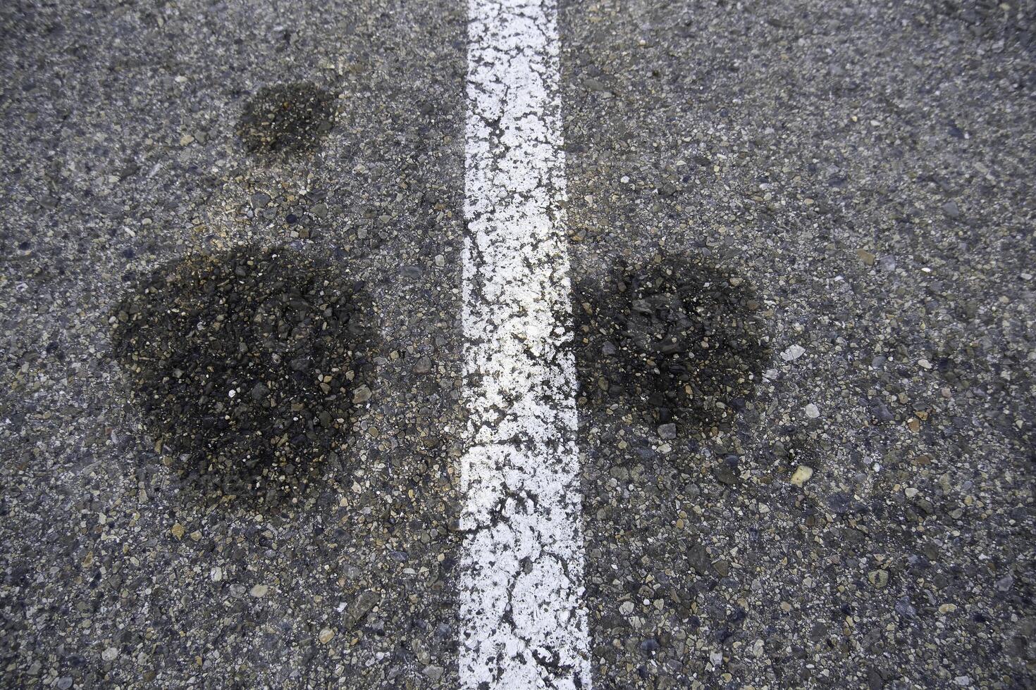 Asphalt road with oil stains photo