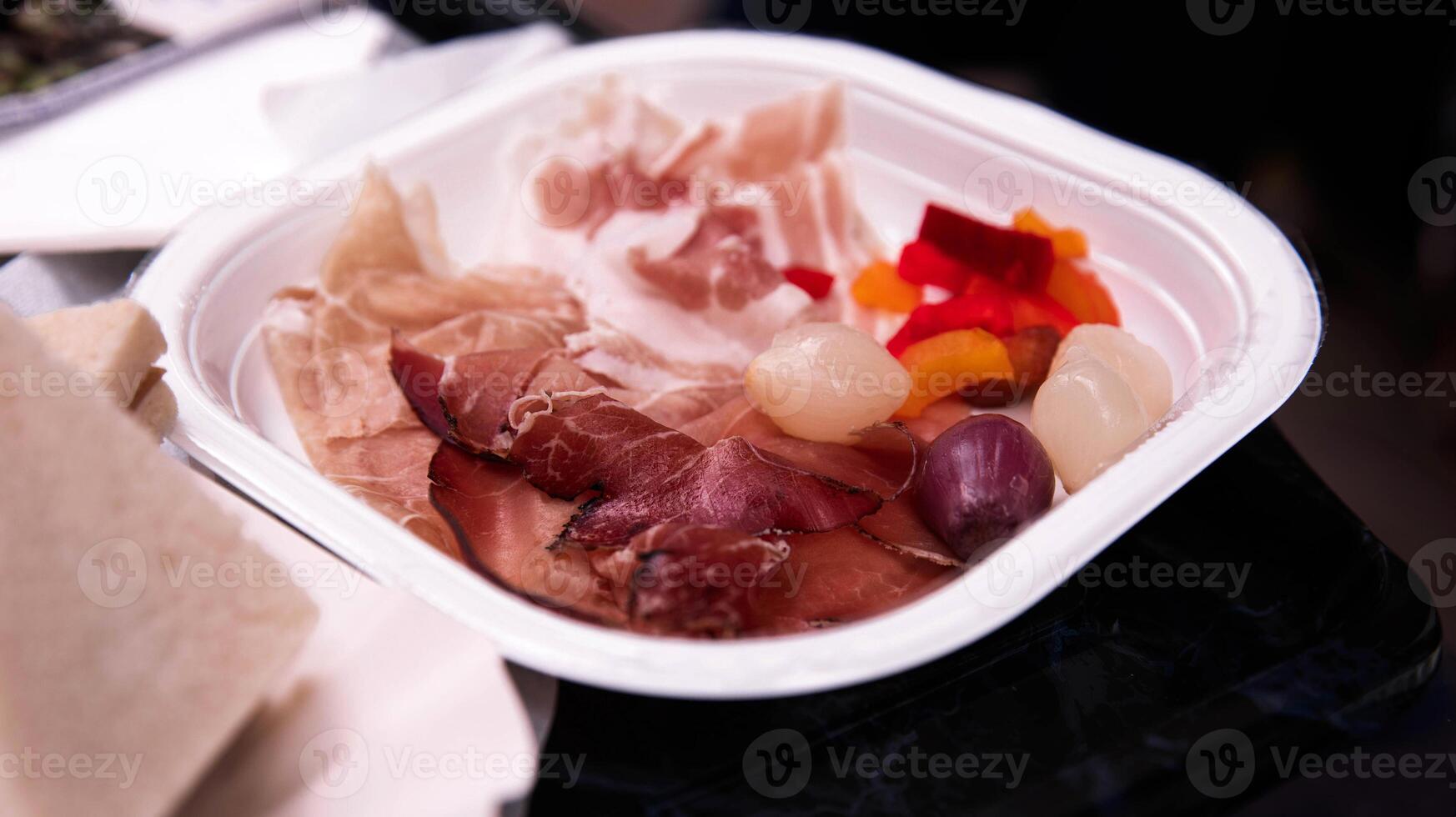 Gourmet Cured Meat and Pickled Vegetables on a Serving Plate photo