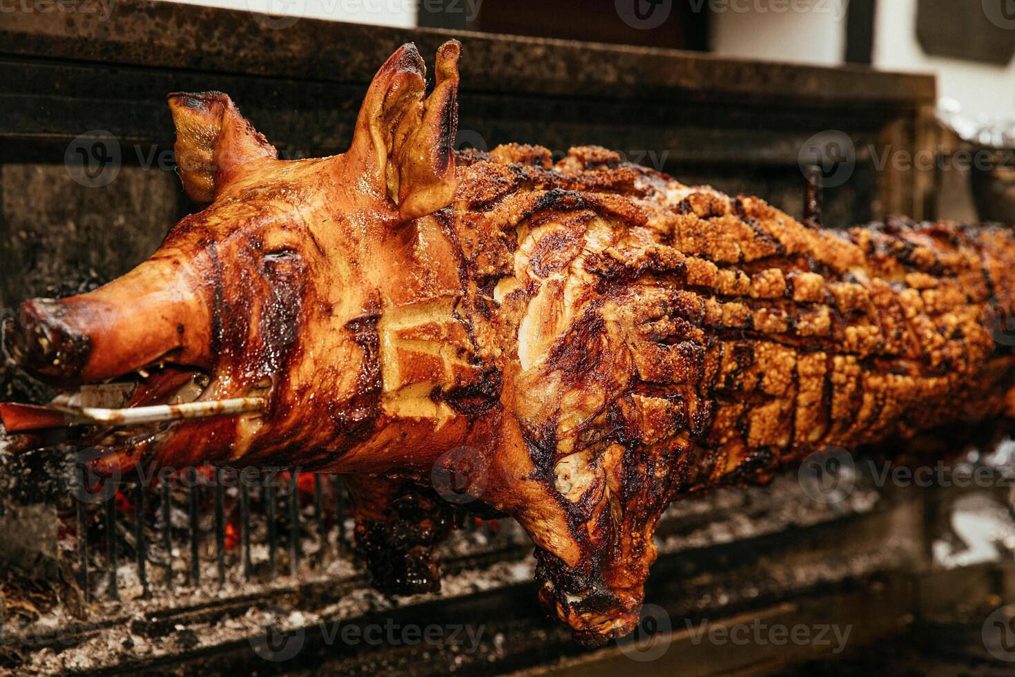 Close-up of a Roasted Whole Pig on a Spit at a Barbecue photo