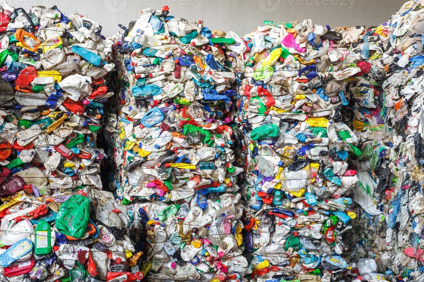 Plastic pressed bales at the modern waste hazardous processing plant. Separate garbage collection. Recycling and storage of waste for further disposal. Business for sorting and processing of waste. photo
