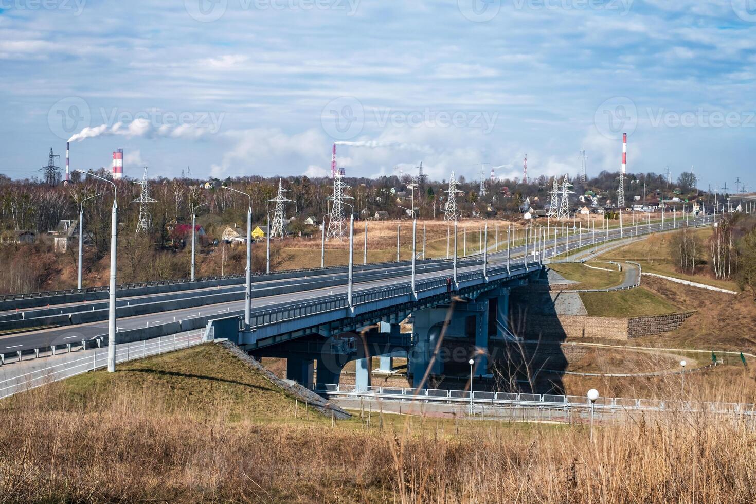 steel frame and concrete construction huge car bridge across the wide river photo