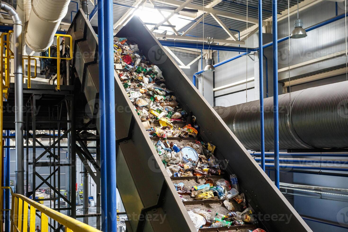 moving conveyor transporter on Modern waste recycling processing plant. Separate and sorting garbage collection. Recycling and storage of waste for further disposal. photo