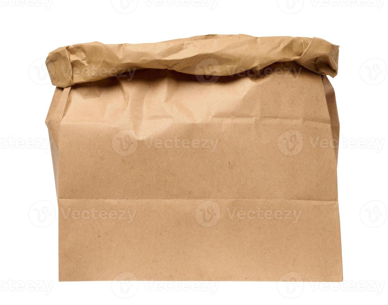 A large empty brown kraft paper bag for packaging products in stores on an isolated background photo