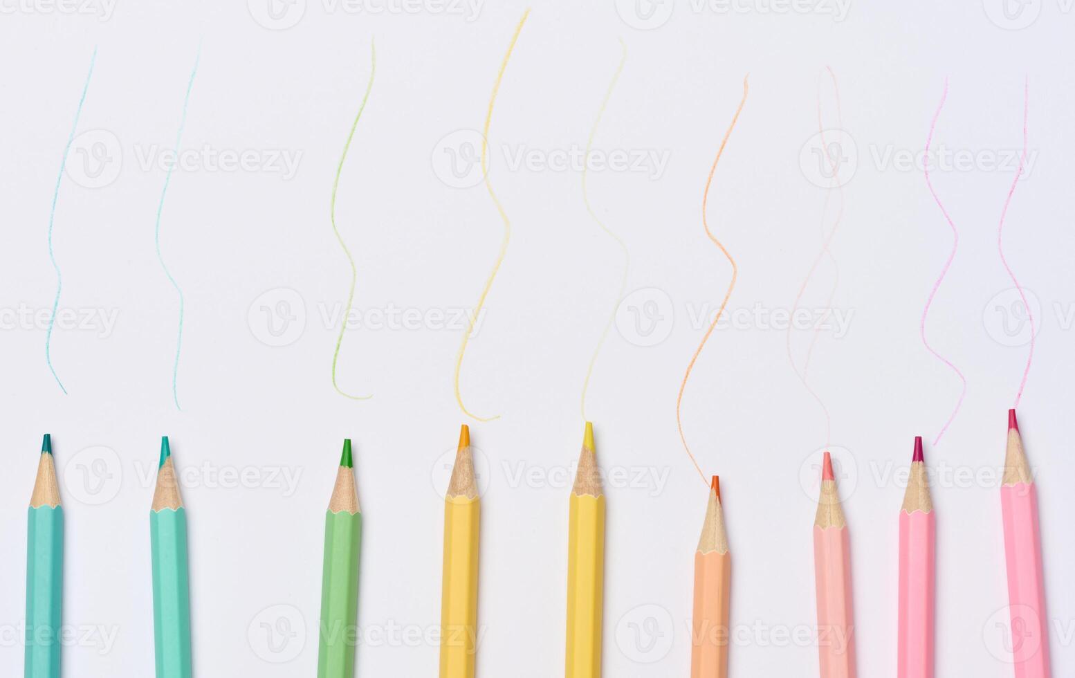 Multi-colored wooden pencils on a white background photo