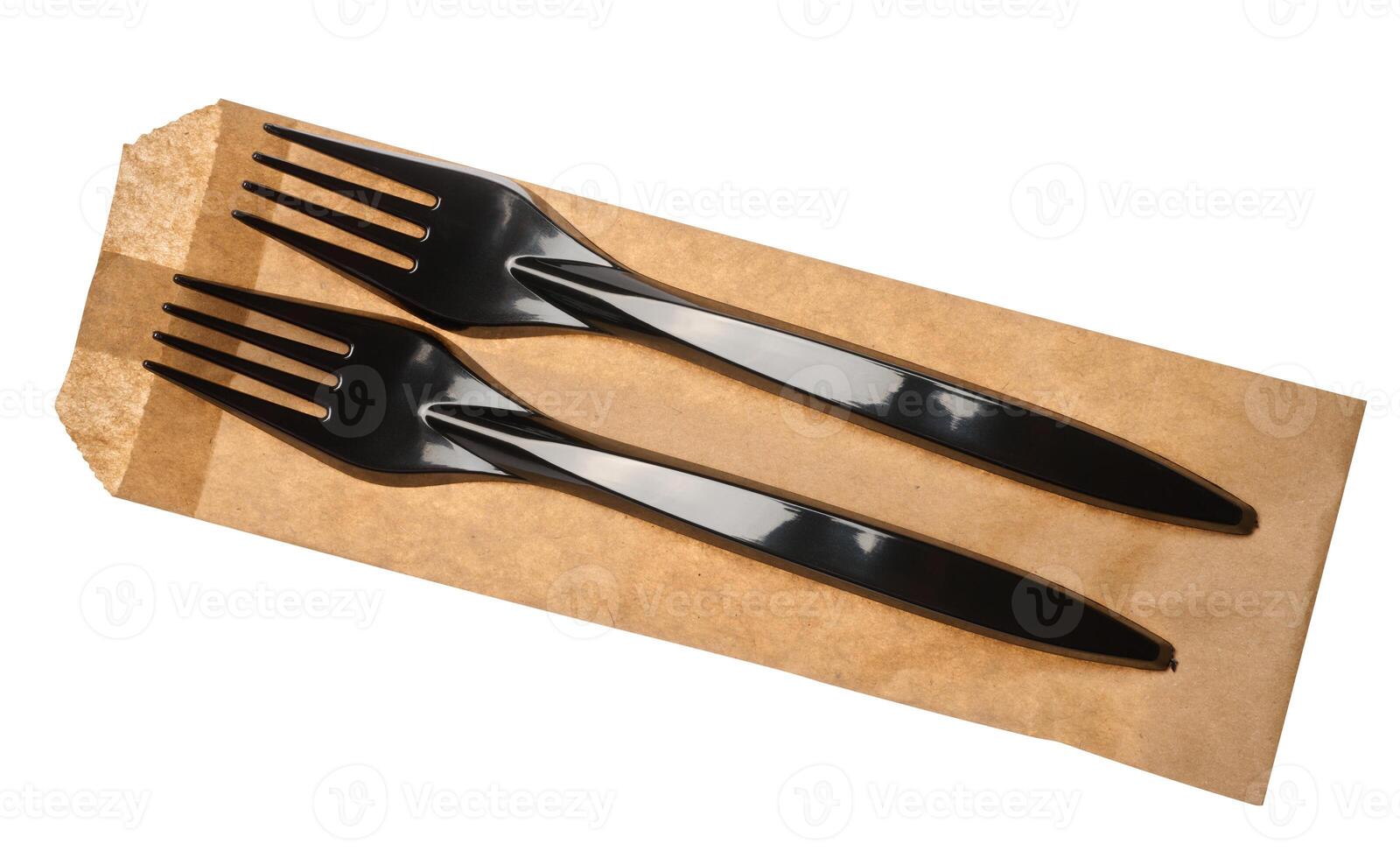 Plastic black forks and paper envelope on isolated background, top view photo