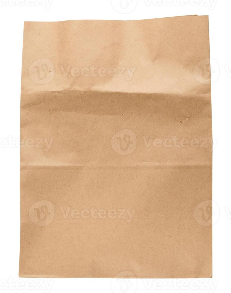 A large empty brown kraft paper bag for packaging products in stores on an isolated background photo