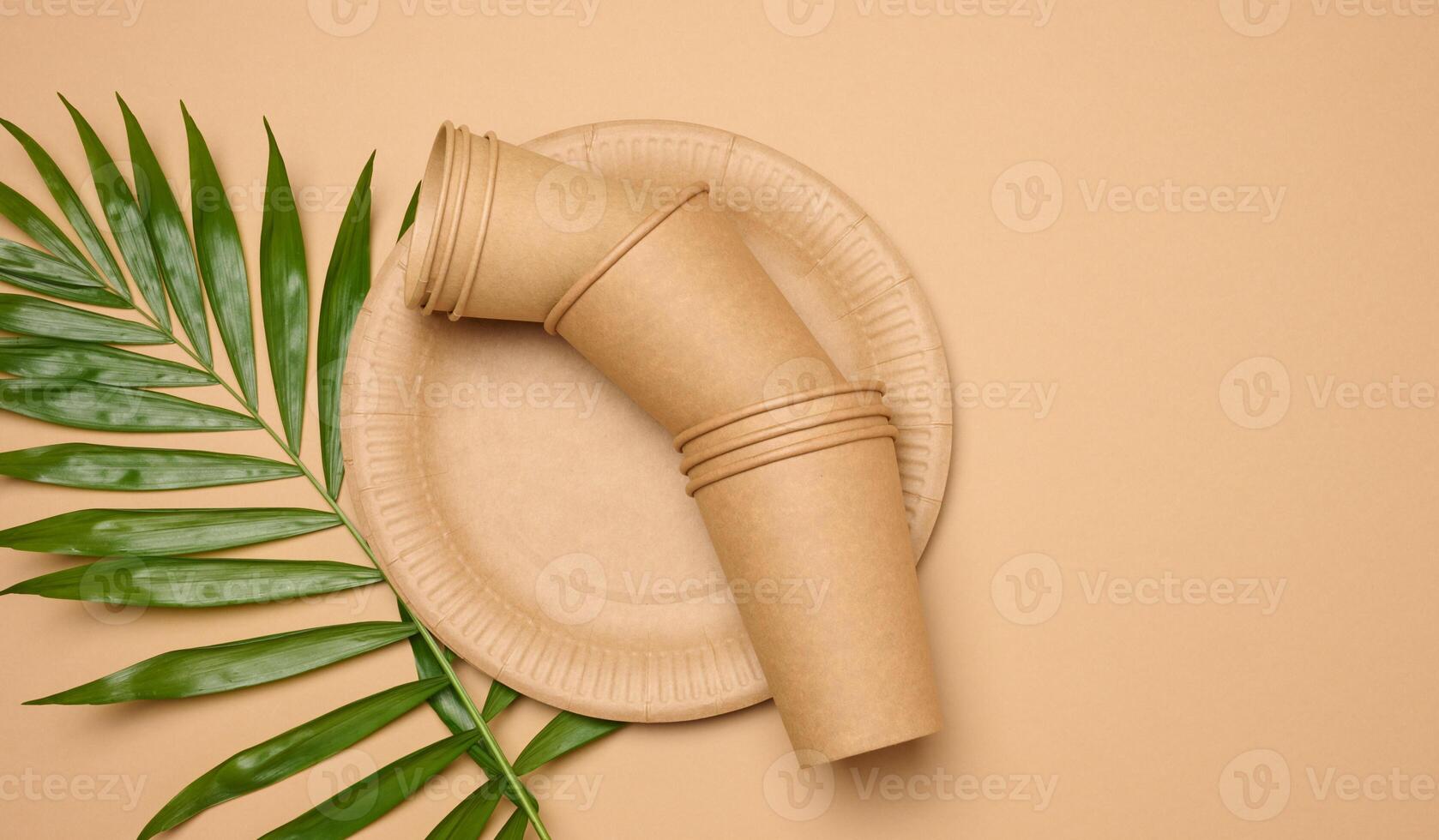 Paper plates and cups on a beige background photo