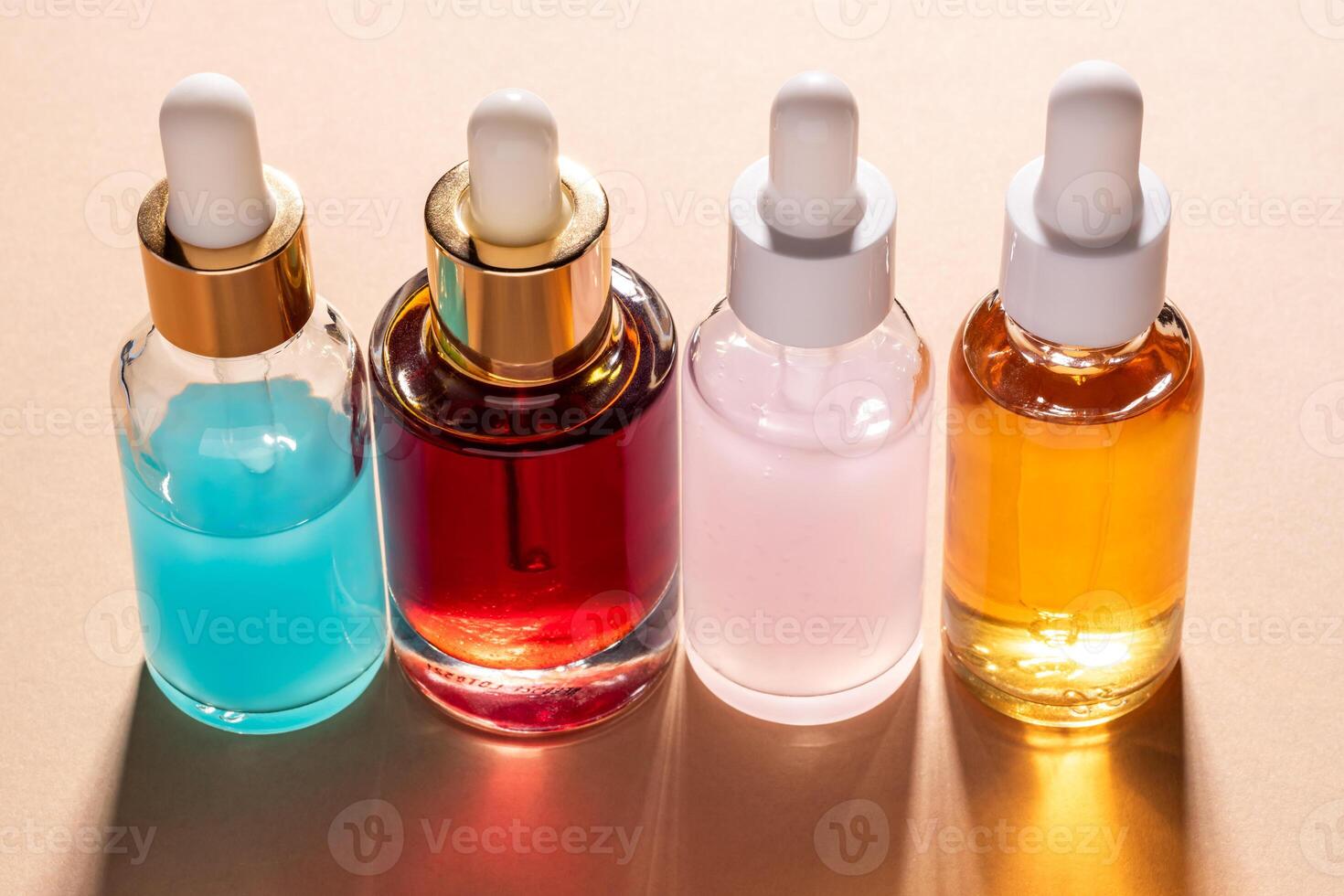 Face serum dropper bottles on white podiums on beige background. Home routine skin care cosmetic set. Unbranded bottles for your design. photo