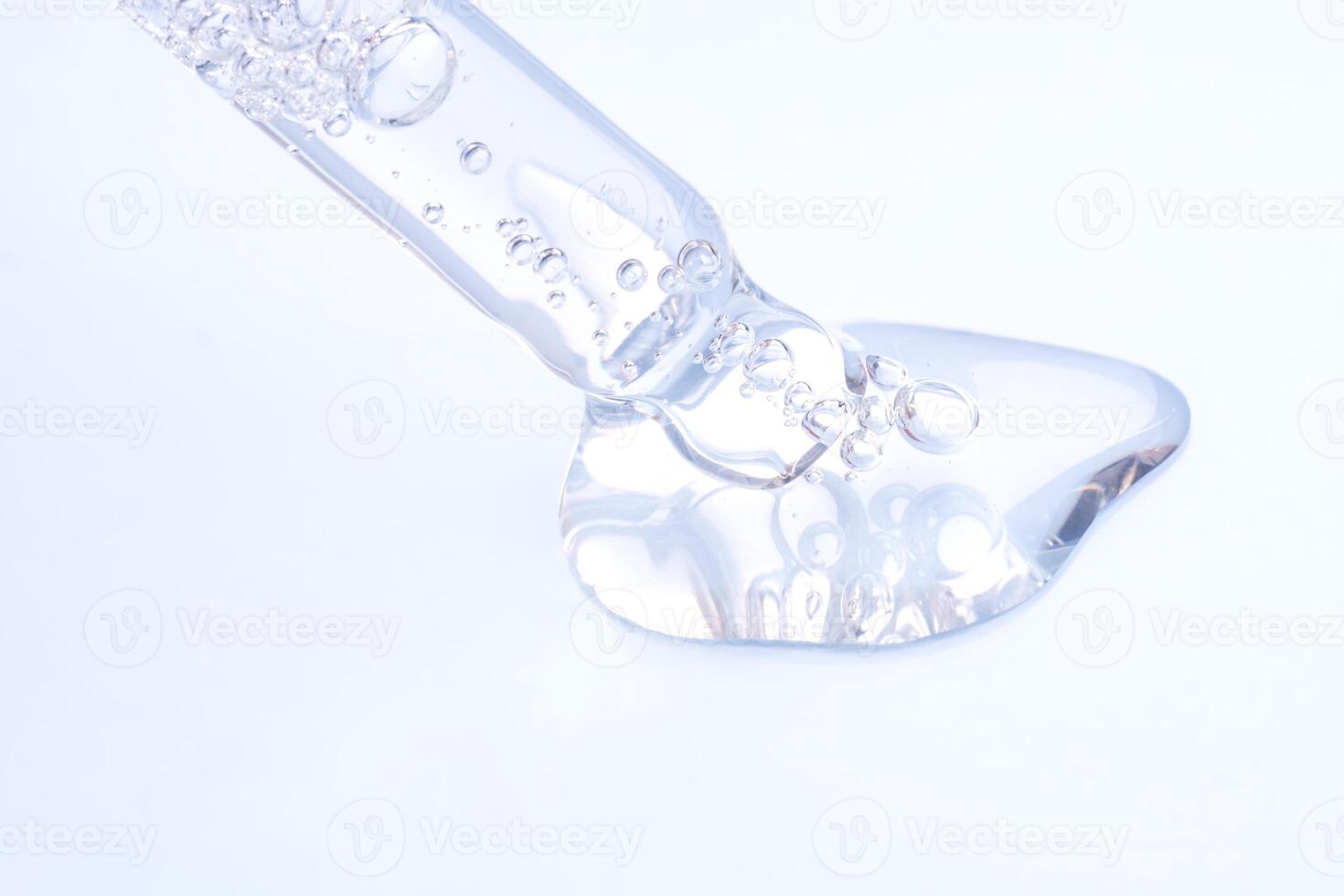 Pipette with sample of gels cosmetic product in petri dish on blue background, hard shadows, selective focus photo