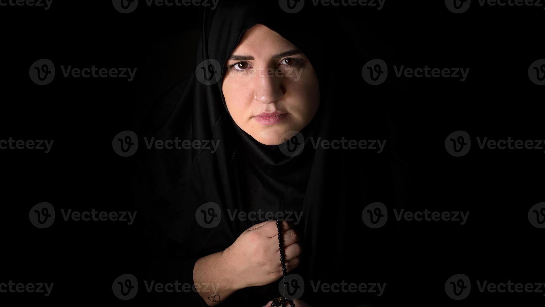 Religious muslim woman in prayer outfit photo