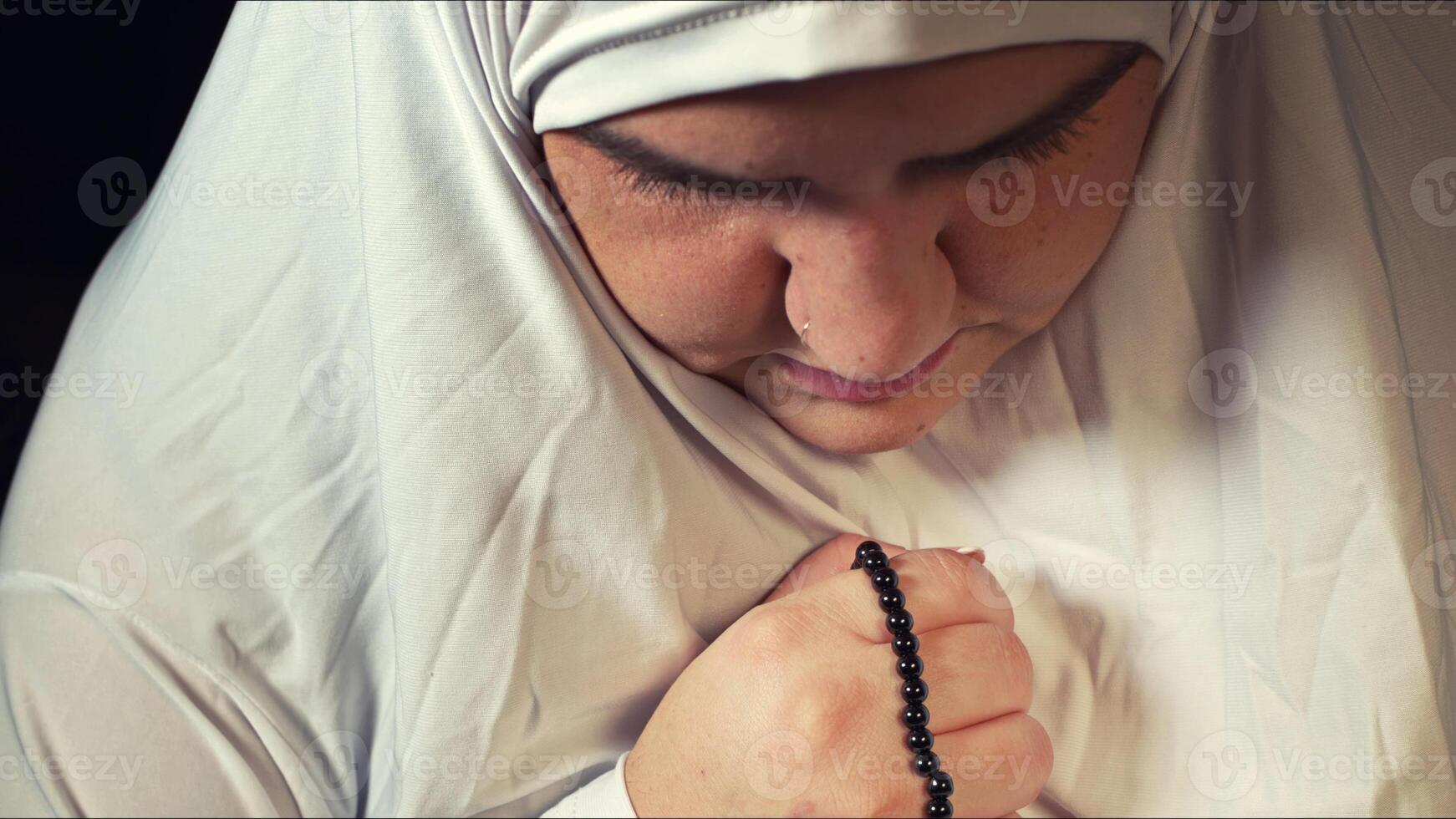 Religious muslim woman in prayer outfit photo