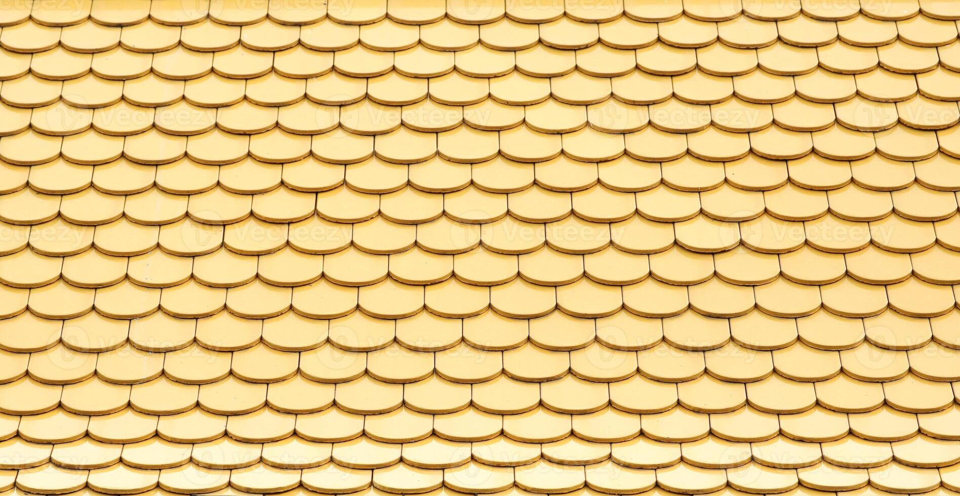 Yellow ceramic tiled roof pattern. photo