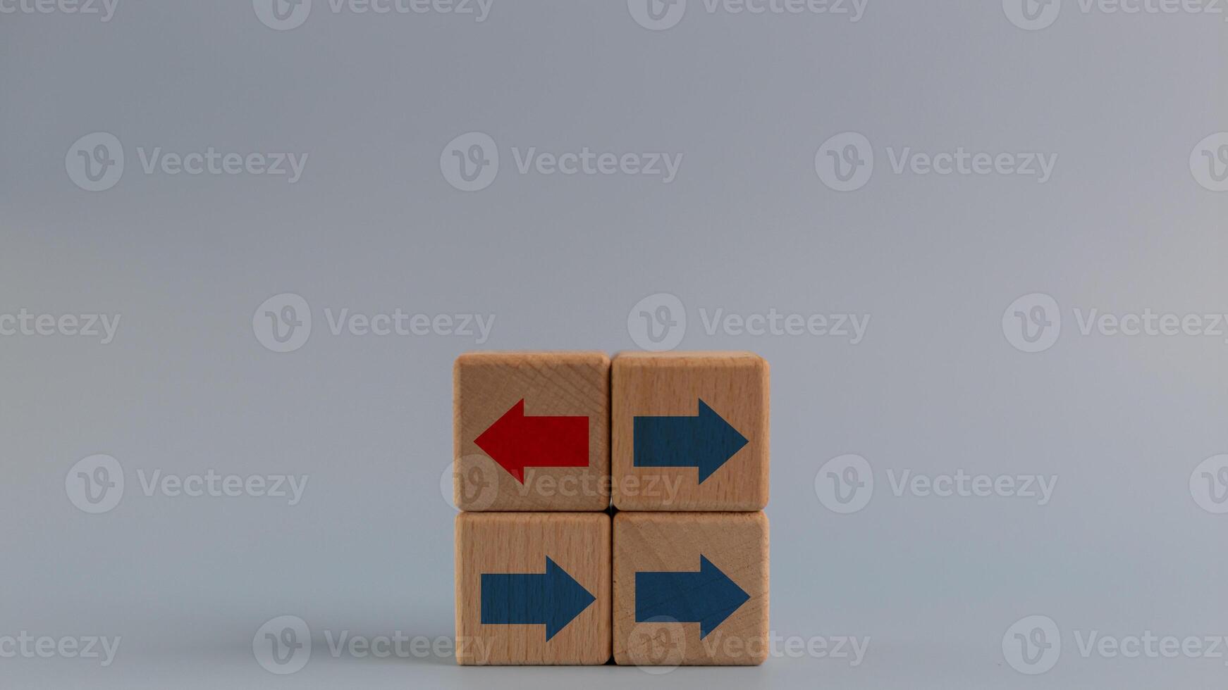 Business icons for innovative, solution, Unique, think different, and individual concepts, arrows on red wooden blocks individual pointing in different way, copy space photo