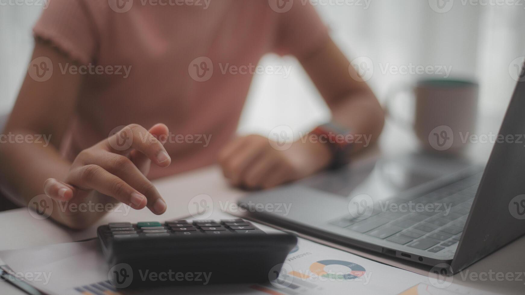 Women use calculators and laptops, check business bills, sit at the table with financial documents, manage planning budgets, and accounting expenses, browse Internet service. photo