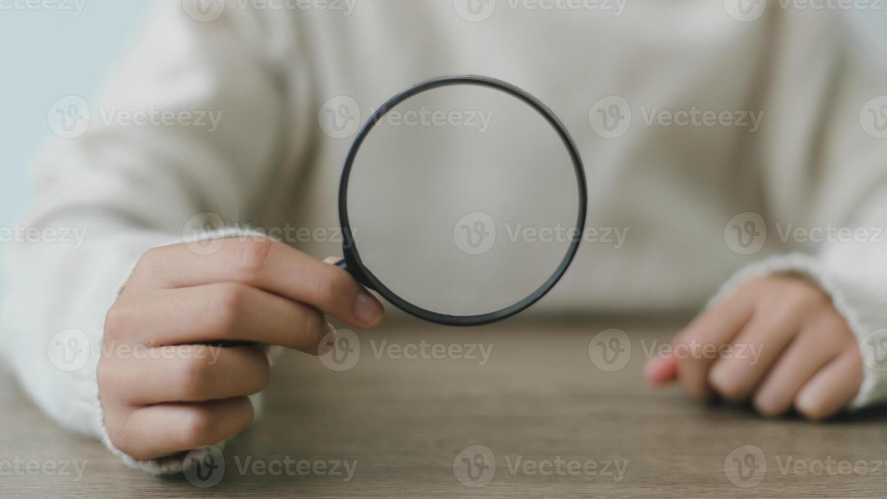 Woman holding magnifying glass, closeup. Find keywords concept photo