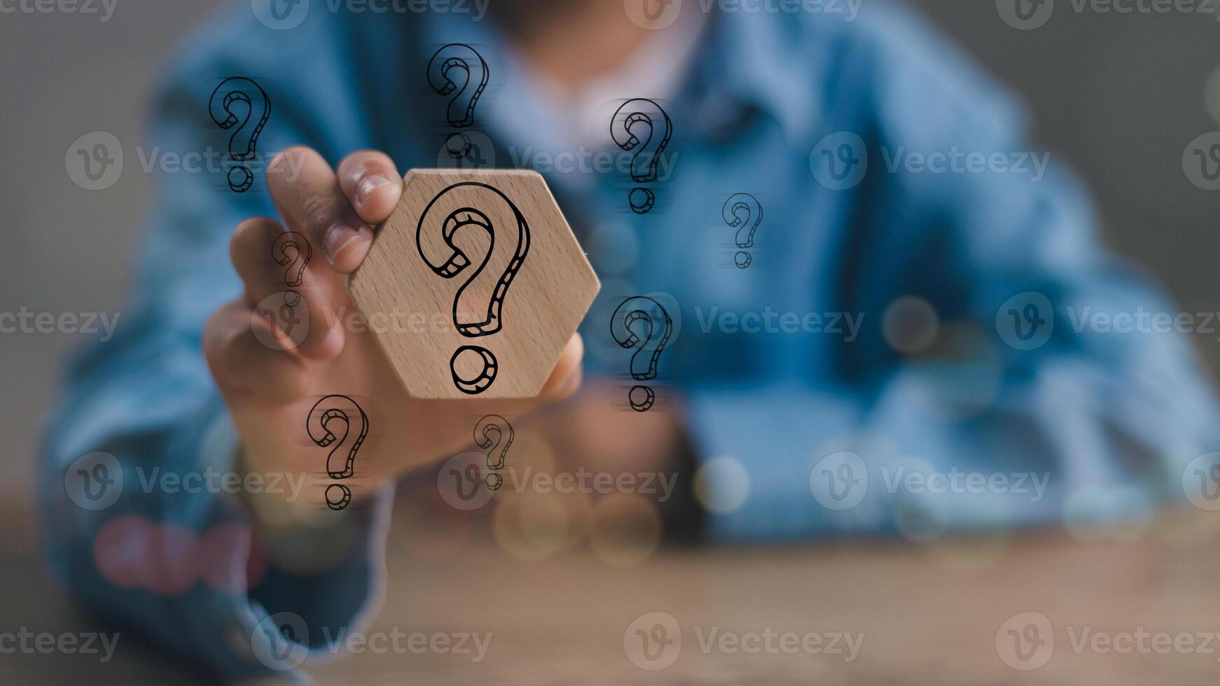 Businessmen holding Questions Mark on the wooden block. FAQ frequently asked questions, Answer, Q and A, Information, Communication and interrogation Concepts photo