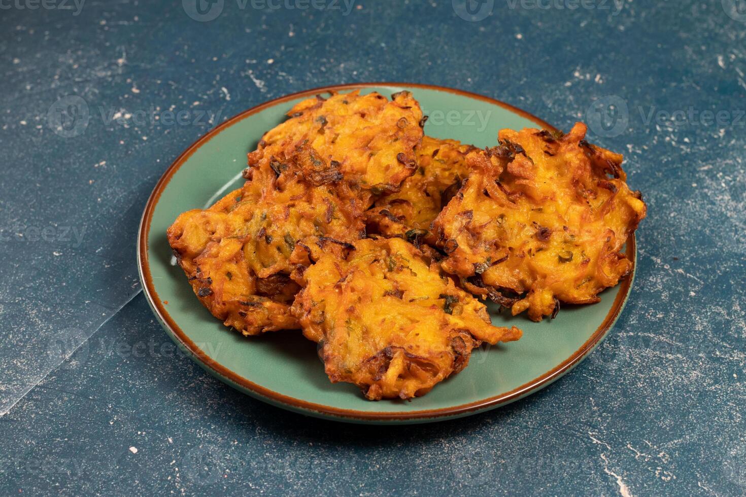 Indian spicy vegetable pakora or pakoda served in dish isolated on table top view photo