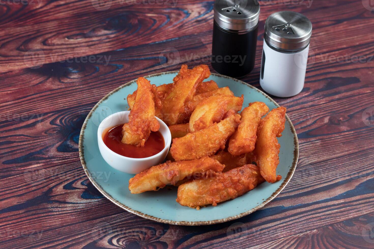 Potatos wedges with tomato sauce served in dish isolated on background side view of fastfood photo