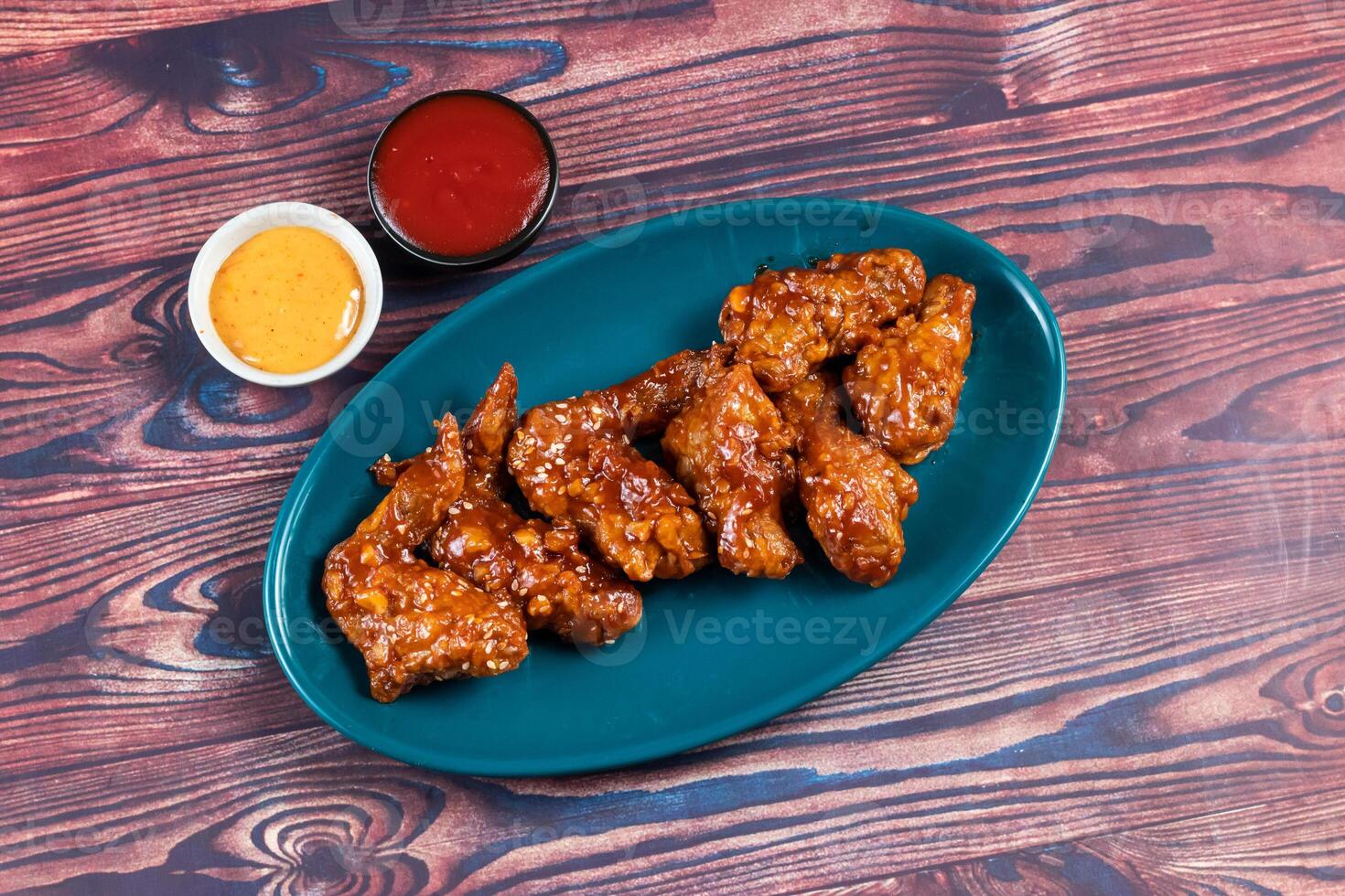 crispy chicken wings with ketchup and mayo dip served in dish isolated on background top view photo