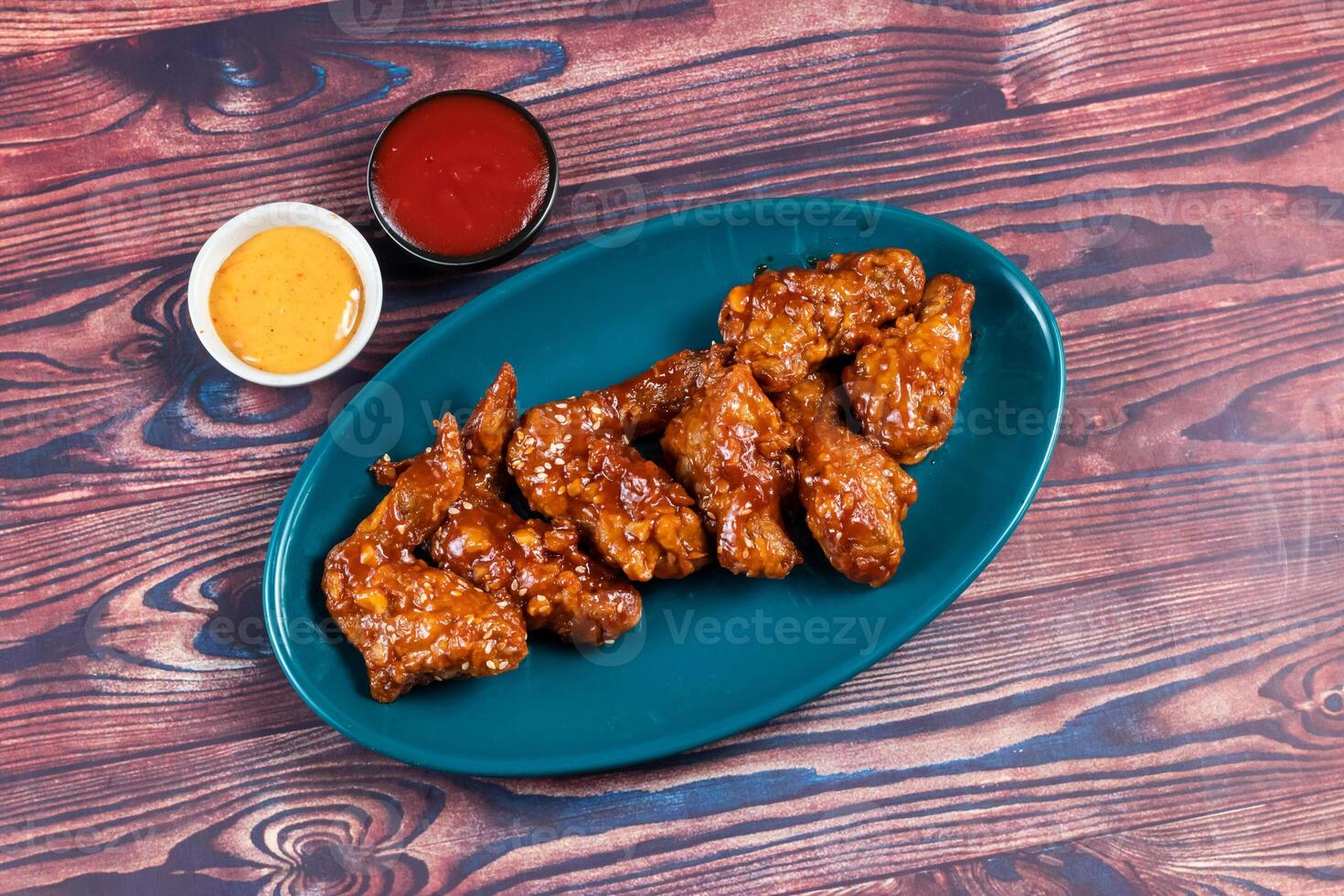 crispy chicken wings with ketchup and mayo dip served in dish isolated on background top view photo