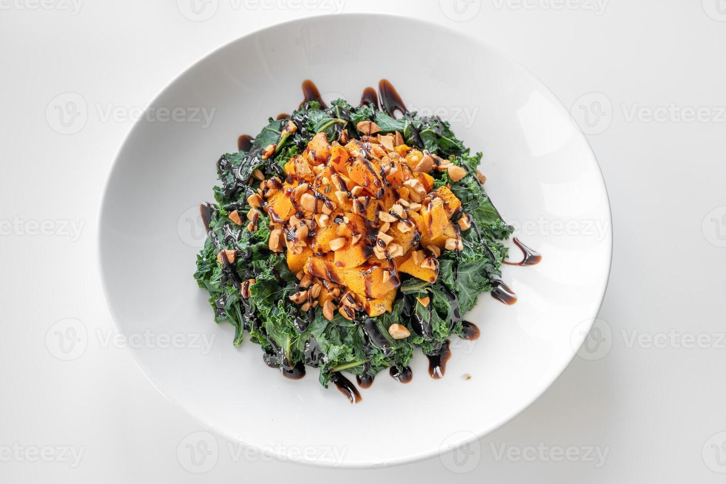 Kale and Squash Salad served in a dish isolated on grey background top view photo