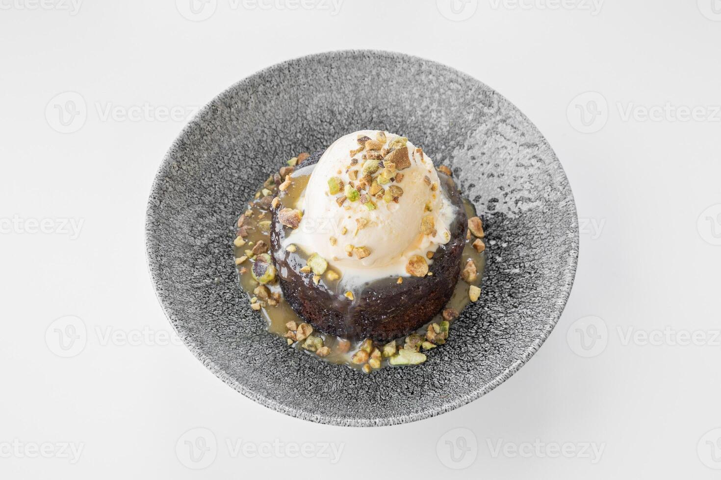 Sticky Toffee Pudding served in a dish isolated on grey background side view photo