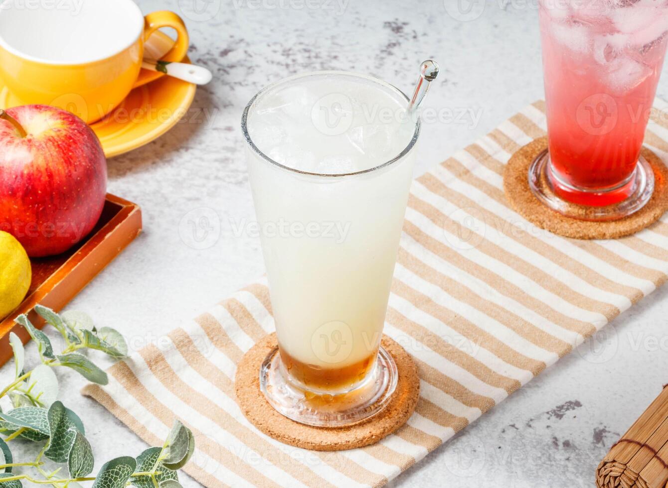 Fresh iced Apple Happy Pi with glass of fruit juice ongrey background. Healthy drinks concept photo