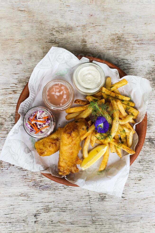 Fried Chicken Dinner with chips, mayo dip, and chilli sauce served in a dish isolated on background top view of fastfood photo