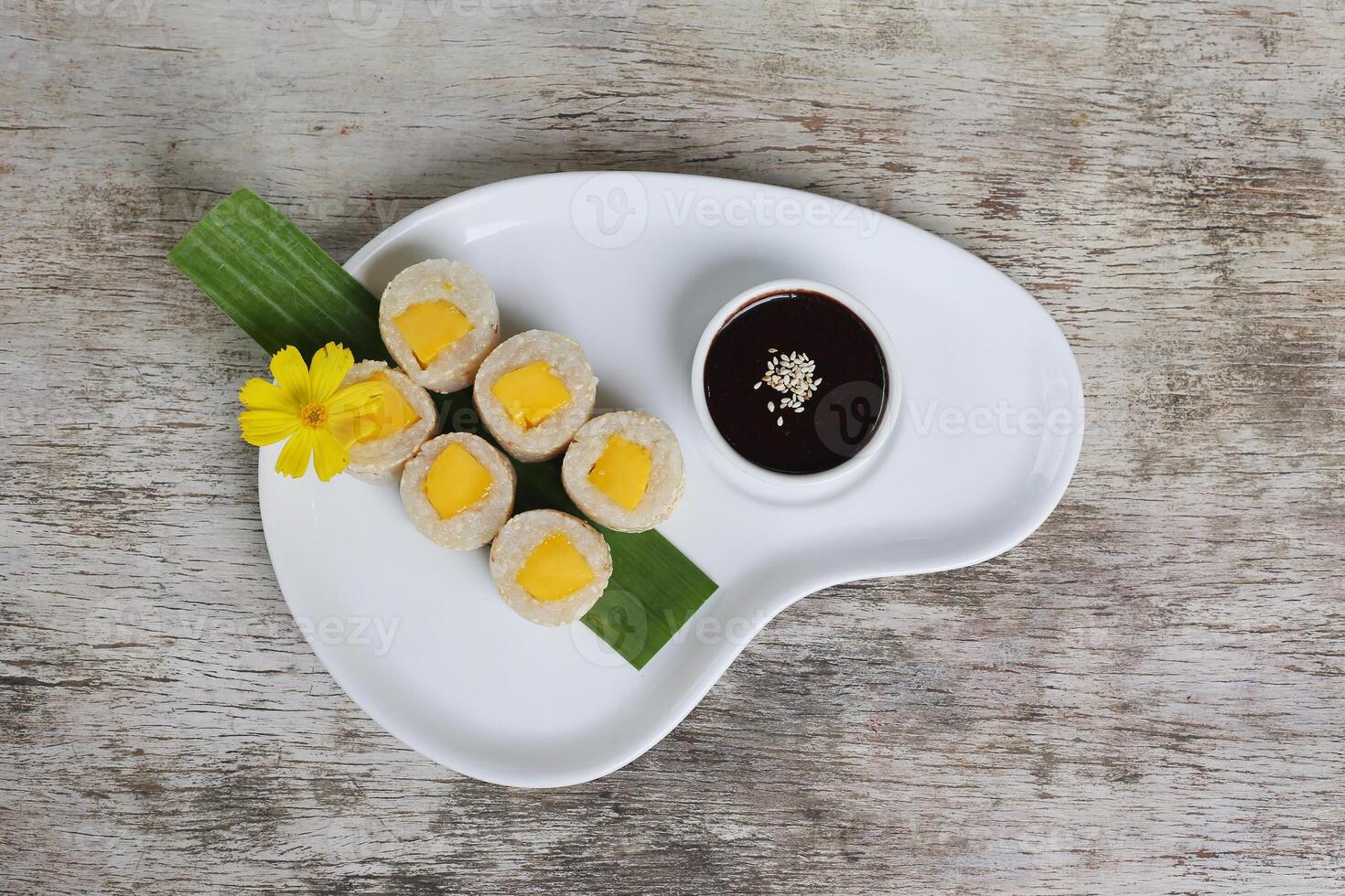 Mango suman sushi cake with soya sauce served in a dish isolated on background top view of dessert photo