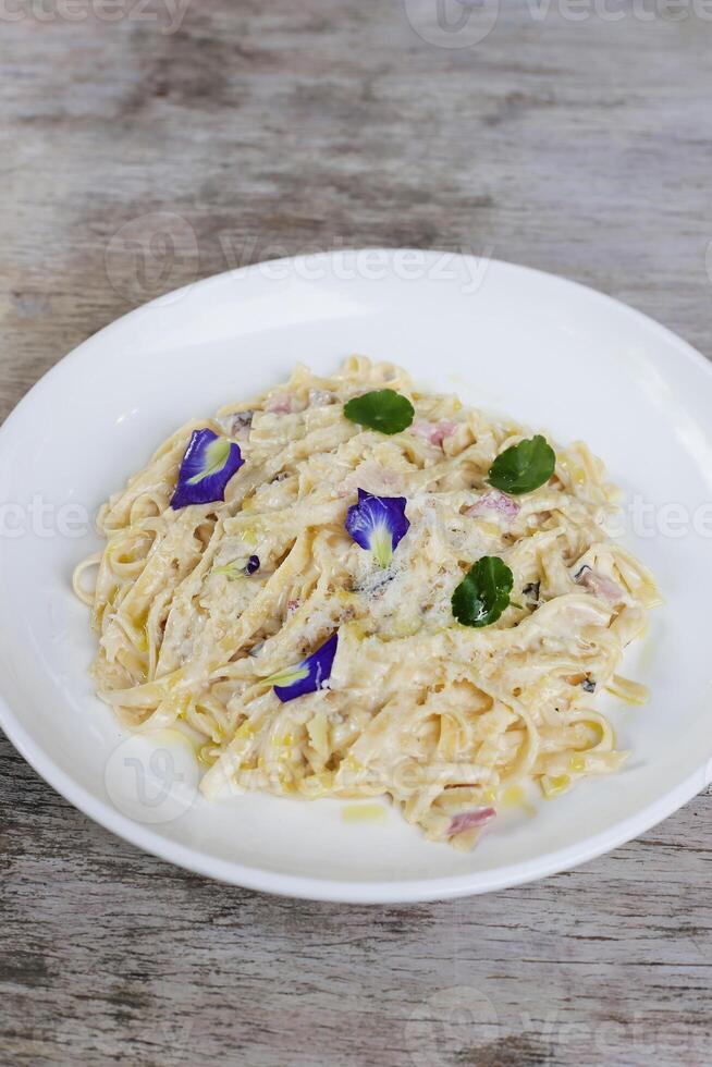 Truffled Mushroom, Bacon, Egg Fettucine pasta noodles served in a dish isolated on grey background side view photo